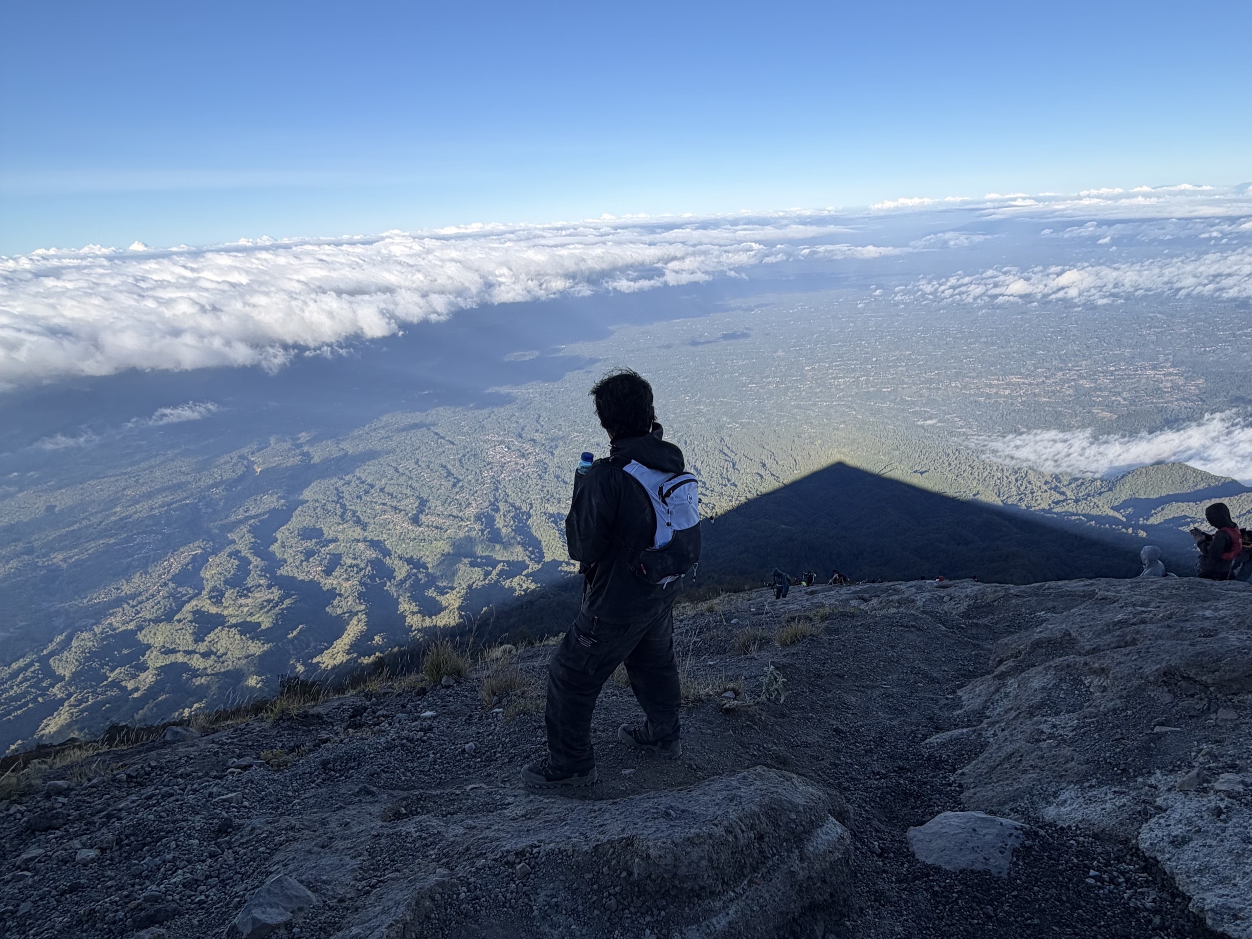 Hiker overlooking the landscape from a mountain summit